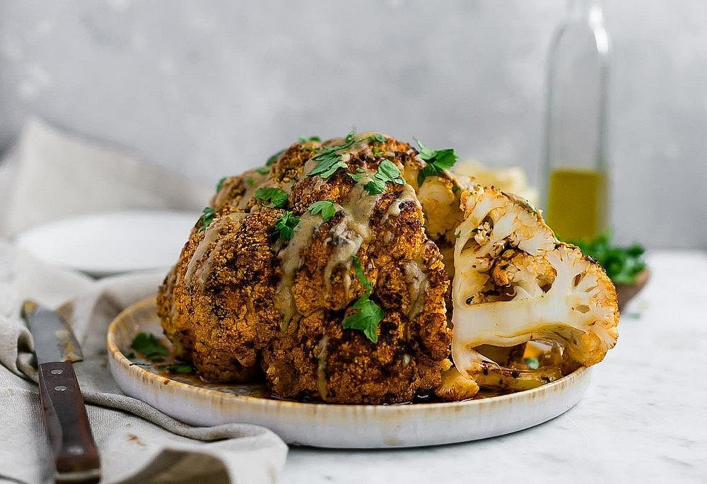 Roasted whole cauliflower with gravy and herbs