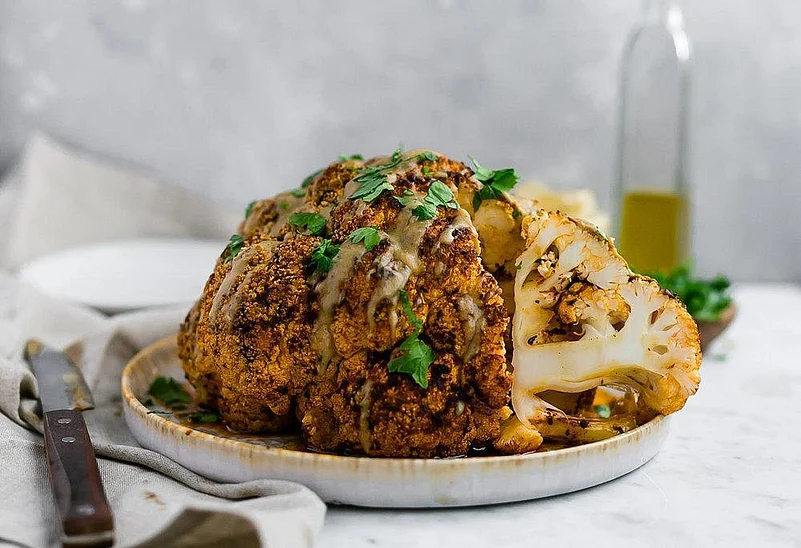 Roasted whole cauliflower with gravy and herbs