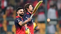 AP : Royal Challengers Bengaluru's Virat Kohli, left, gestures to the fans as he walks out with teammate Tim David after winning the Indian Premier League match against Sunrisers Hyderabad in Bengaluru.