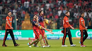 (AP Photo/Aijaz Rahi) : Royal Challengers Bengaluru's Virat Kohli, second left, gestures to the fans as he walks out with teammate Tim David after winning the Indian Premier League cricket match against Sunrisers Hyderabad in Bengaluru, India, Saturday, March 28, 2026
