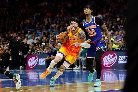 Charlotte Hornets guard LaMelo Ball, left, drives against New York Knicks guard Jordan Clarkson during the second half of an NBA basketball game in Charlotte, N.C.