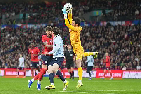 England's Ben White, left, and England's goalkeeper James Trafford defend during the international friendly soccer match between England and Uruguay in London.