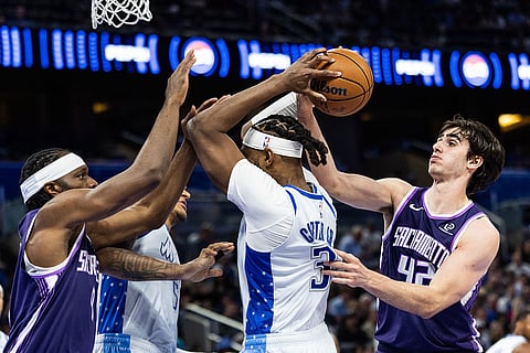 Orlando Magic center/forward Wendell Carter Jr. (34) fights for the ball with Sacramento Kings center Maxime Raynaud (42) during the first half of an NBA basketball game in Orlando, Fla.