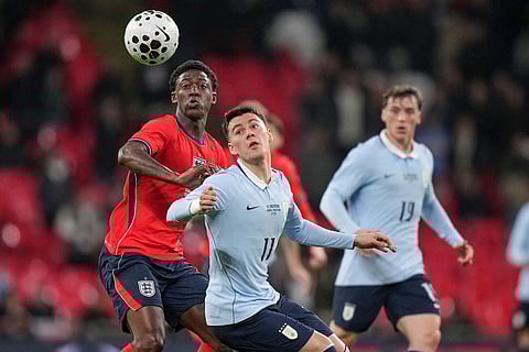 England's Kobbie Mainoo, left, challenges Uruguay's Facundo Pellistri during the international friendly soccer match between England and Uruguay in London.