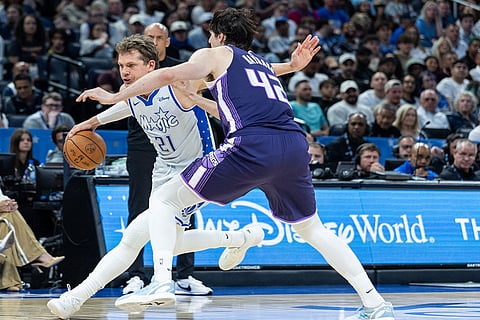 Orlando Magic forward/center Moritz Wagner (21) dribbles by Sacramento Kings center Maxime Raynaud (42) during the second half of an NBA basketball game in Orlando, Fla.