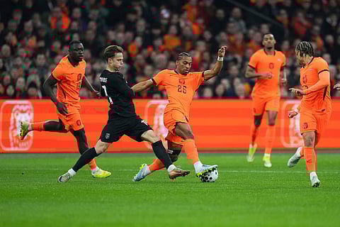 Netherlands' Quinten Timber, centre, and Brian Brobbey, left, challenge for the ball with Norway's Felix Horn Myhre, second from left, during the international friendly soccer match between the Netherlands and Norway in Amsterdam, Netherlands.