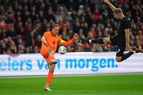 Netherlands' Virgil van Dijk, left, and Norway's Alexander Sorloth challenge for the ball during the international friendly soccer match between the Netherlands and Norway in Amsterdam, Netherlands.
