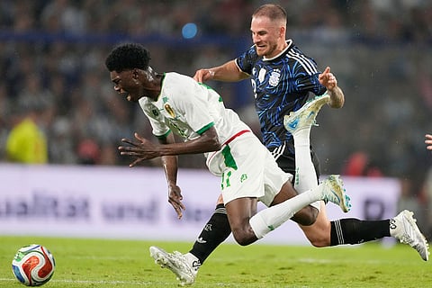Mauritania's Maata Magassa, left and Argentina's Alexis Mac Allister chase the ball during a friendly march in Buenos Aires, Argentina.