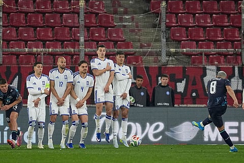 Paraguay's Diego Gomez, right, scores his side's opening goal during the international friendly soccer match between Greece and Paraguay in Piraeus, Greece.