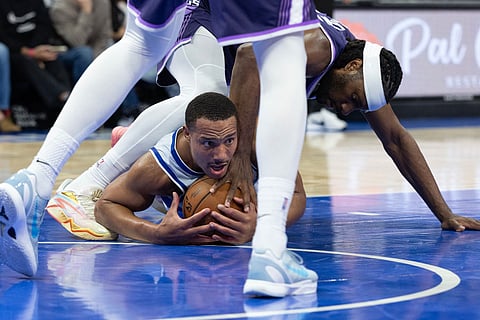 Orlando Magic guard Desmond Bane (3) fights for the ball with Sacramento Kings forward Precious Achiuwa (9) during the second half of an NBA basketball game in Orlando, Fla.
