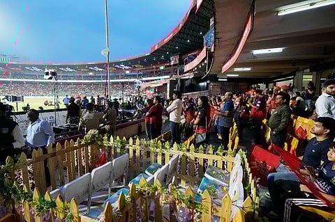Eleven seats are kept at M Chinnaswamy Stadium as a tribute to 11 Royal Challengers Bengaluru fans who lost their lives in a stampede last year, as spectators wait for the Indian Premier League cricket match between Royal Challengers Bengaluru and Sunrisers Hyderabad to begin, in Bengaluru, India, Saturday, March 28, 2026. 