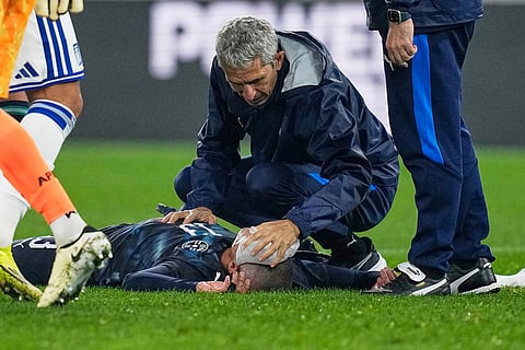 Paraguay's Alan Benitez receives medical attention during the international friendly soccer match between Greece and Paraguay in Piraeus, Greece.