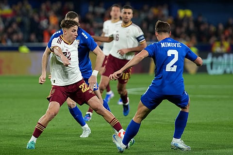 Spain's Fermin Lopez, left, and Serbia's Ognjen Mimovic challenge for the ball during the international friendly soccer match between Spain and Serbia in Villarreal, Spain.