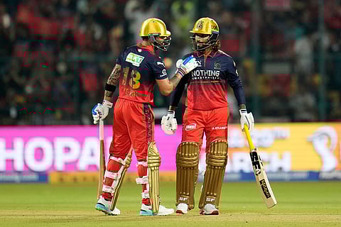 Royal Challengers Bengaluru's Virat Kohli, left, and batting partner Rajat Patidar chat during the Indian Premier League cricket match between Royal Challengers Bengaluru and Sunrisers Hyderabad in Bengaluru, India.