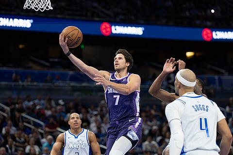 Sacramento Kings forward Doug McDermott (7) lays the ball up during the first half of an NBA basketball game, against the Orlando Magic in Orlando, Fla. 