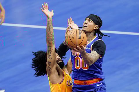 New York Knicks guard Jordan Clarkson (00) drives to the basket against Charlotte Hornets guard Coby White during the first half of an NBA basketball game in Charlotte, N.C.