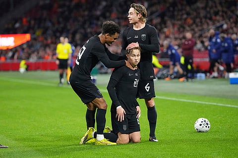 Norway's Andreas Schjelderup, centre, celebrates with Patrick Berg, right, and Oscar Bobb after scoring the opening goal during the international friendly soccer match between the Netherlands and Norway in Amsterdam, Netherlands.