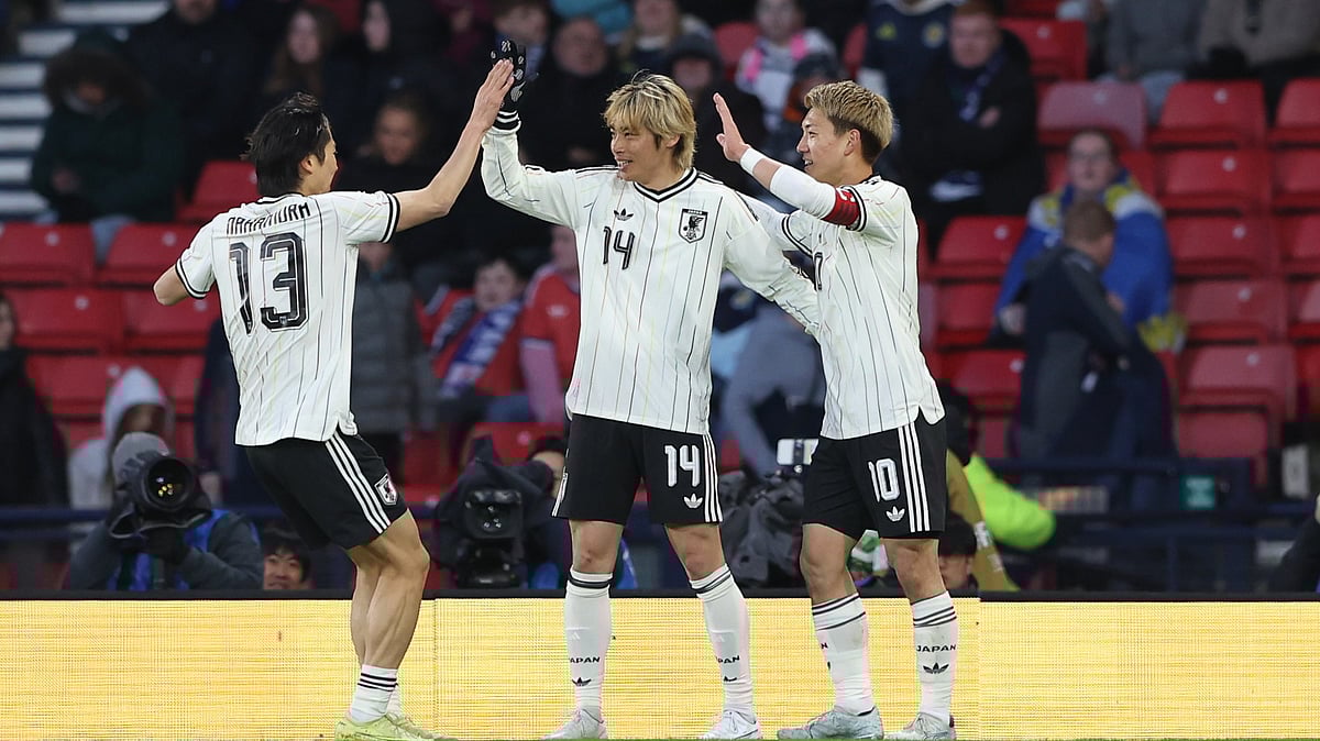Japan's Junya Ito, centre, celebrates with Japan's Keito Nakamura, left, and Japan's Ritsu Doan after scoring his side's opening goal during the international friendly soccer match between Scotland and Japan in Glasgow, Scotland, Saturday, March 28, 2026. - (AP Photo/Scott Heppell)