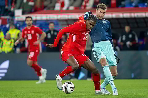 Switzerland's Joel Monteiro, left, battles for the ball with Germany's Leon Goretzka, right, during an international friendly soccer match between Switzerland and Germany in Basel, Switzerland.