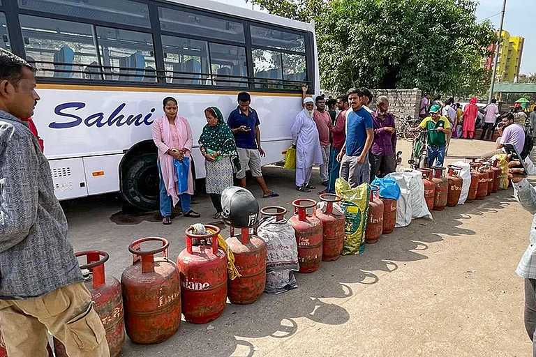 People queue up to avail LPG cylinders amid ongoing supply crunch, in Dilshad Colony, New Delhi. - | Photo: PTI/Arvind Kumar
