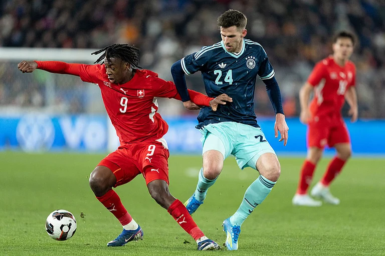 Switzerland's Johan Manzambi, left, shields the ball from Germany's Anton Stach, during an international friendly soccer match between Switzerland and Germany in Basel, Switzerland. - | Photo: Claudio Thoma/Keystone via AP