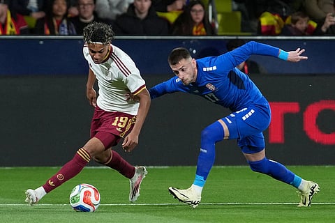 Spain's Lamine Yamal, left, and Serbia's Aleksa Terzic challenge for the ball during the international friendly soccer match between Spain and Serbia in Villarreal, Spain.