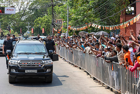 People gather as Prime Minister Narendra Modi, unseen, arrives for a public meeting, in Palakkad, Kerala. 