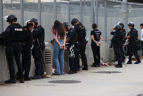 Police arrest a protesters in downtown Los Angeles after a "No Kings" rally.