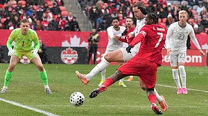 | Photo: AP/Chris Young : Canada's Jonathan David tries to square the ball despite pressure from Iceland's Sverrir Ingi Ingason during International friendly soccer action in Toronto on Saturday March 28, 2026.