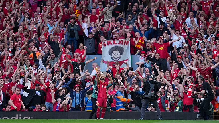Liverpool's Mohamed Salah takes a selfie with a fans smartphone as he celebrates after scoring his side's fourth goal during the English Premier League soccer match between Liverpool and Tottenham Hotspur at Anfield in Liverpool, England, Sunday, April 27, 2025. - | Photo: AP/Jon Super