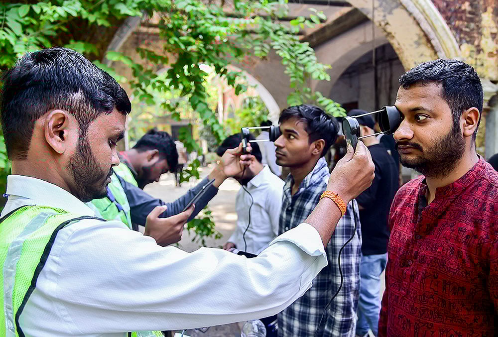 Aspirants undergo security checks before they are allowed to appear for the Combined State/Upper Subordinate Services (PCS) Mains Examination 2025 conducted by the Uttar Pradesh Public Service Commission, in Prayagraj, Uttar Pradesh. - | Photo: PTI