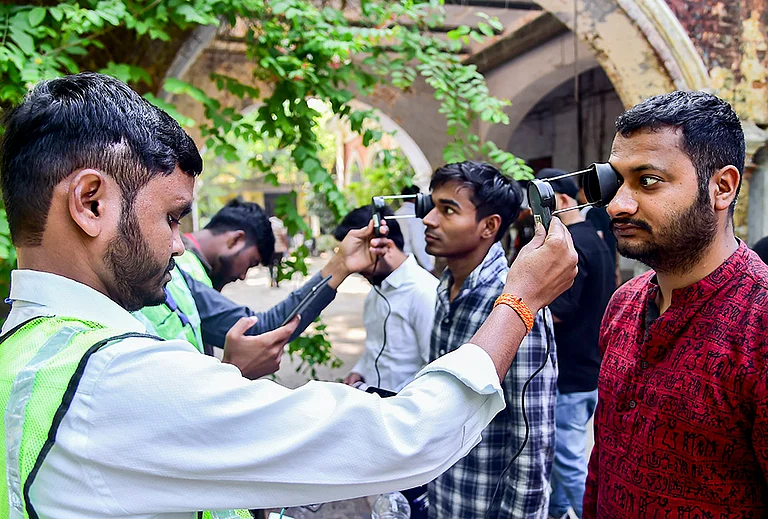 Aspirants undergo security checks before they are allowed to appear for the Combined State/Upper Subordinate Services (PCS) Mains Examination 2025 conducted by the Uttar Pradesh Public Service Commission, in Prayagraj, Uttar Pradesh. - | Photo: PTI
