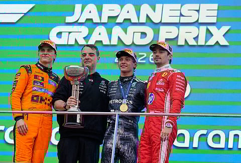 Race winner Mercedes driver Kimi Antonelli of Italy stands with second placed McLaren driver Oscar Piastri, left, of Australia, third placed Ferrari driver Charles Leclerc, right, of Monaco and Giacomo Tortora, second left, Director of Car Design at Mercedes on the podium following the Japanese Formula One Grand Prix at Suzuka in central Japan.
