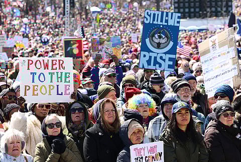 Protesters watch performers during the "No Kings" march in St. Paul, Minnesota.
