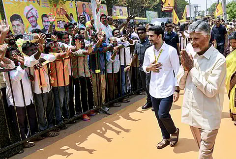 Andhra Pradesh Chief Minister N Chandrababu Naidu, right, greets the gathering during the 44th Founding Day celebrations of the Telugu Desam Party, at party office in Mangalagiri, Andhra Pradesh. 