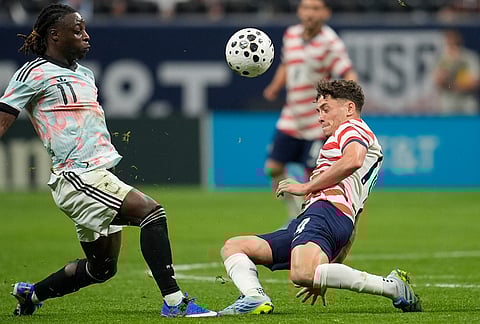 United States' Sebastian Berhalter (14) battles for the ball with Belgium's Jeremy Doku (11) during the second half of an international friendly soccer match in Atlanta.