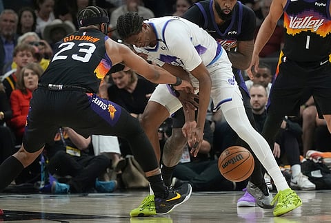 Phoenix Suns guard Jordan Goodwin (23) strips the ball away from Utah Jazz forward Cody Williams (5) during the first half of an NBA basketball game, in Phoenix. 