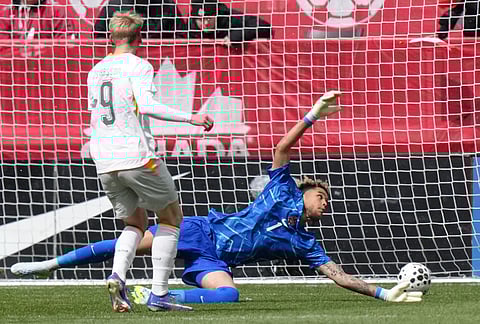 Iceland's Orri Steinn Oskarsson scores a goal past Canada goalkeeper Dayne St. Clair  during an international friendly soccer match in Toronto.