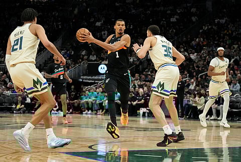 San Antonio Spurs' Victor Wembanyama (1) drives to the basket against Milwaukee Bucks' Pete Nance during the second half of an NBA basketball game in Milwaukee.