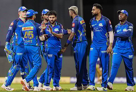 Mumbai Indians' Shardul Thakur celebrates with teammates after taking the wicket of Kolkata Knight Riders' captain Ajinkya Rahane during an Indian Premier League (IPL) 2026 T20 cricket match between Mumbai Indians and Kolkata Knight Riders, at the Wankhede Stadium, in Mumbai, Maharashtra.