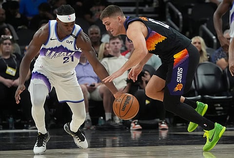 Utah Jazz guard Bez Mbeng (21) steals the ball from Phoenix Suns guard Collin Gillespie during the second half of an NBA basketball game, in Phoenix. 