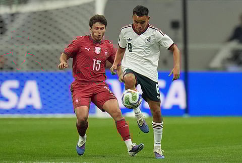 Mexico's Carlos Rodriguez, right, controls the ball past Portugal's Joao Neves during the international friendly soccer match between Mexico and Portugal in Mexico City.