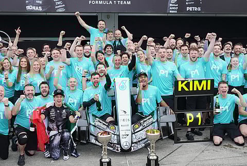 Mercedes driver Kimi Antonelli of Italy celebrates with his teammates during a group photo after Antonelli won the Japanese Formula One Grand Prix race in Suzuka, central Japan.
