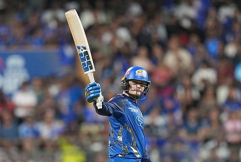 Mumbai Indians' Ryan Rickelton celebrates his fifty runs during the Indian Premier League cricket match between Mumbai Indians and Kolkata Knight Riders in Mumbai.