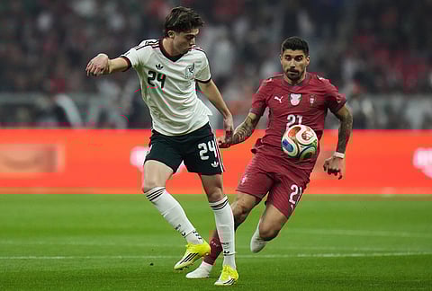 Mexico's Brian Gutierrez, left, kicks the ball past Portugal's Ruben Neves during the international friendly soccer match between Mexico and Portugal in Mexico City.