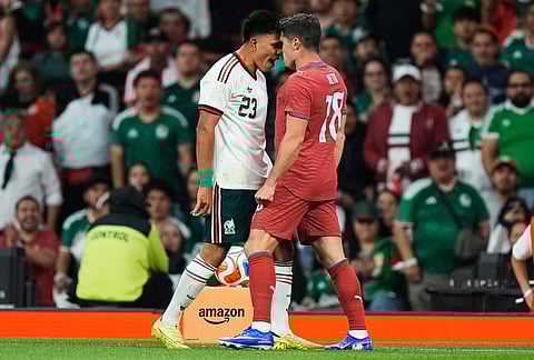 Mexico's Jesus Gallardo, left, argues with Portugal's Pedro Neto during the international friendly soccer match between Mexico and Portugal in Mexico City.