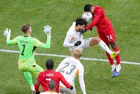 Canada's Daniel Jebbison (24) tries to send a header towards the Iceland goal as he is challenged by Iceland's Mikael Egill Ellertsson during the second half of an international friendly soccer match in Toronto.