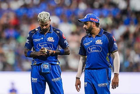 Mumbai Indians' captain Hardik Pandya, left, and Rohit Sharma during an Indian Premier League (IPL) 2026 T20 cricket match between Mumbai Indians and Kolkata Knight Riders, at the Wankhede Stadium, in Mumbai, Maharashtra.