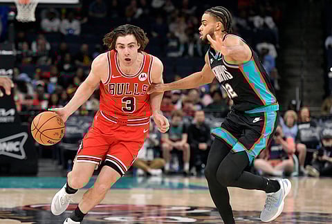 Chicago Bulls guard Josh Giddey (3) handles the ball against Memphis Grizzlies guard Rayan Rupert (32) in the first half of an NBA basketball game in Memphis, Tennessee.
