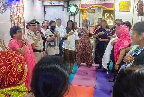 Sex workers gather for a counselling and skill-building session organised by Delhi Police and NGO at a brothel on Garstin Bastion Road, in New Delhi. 